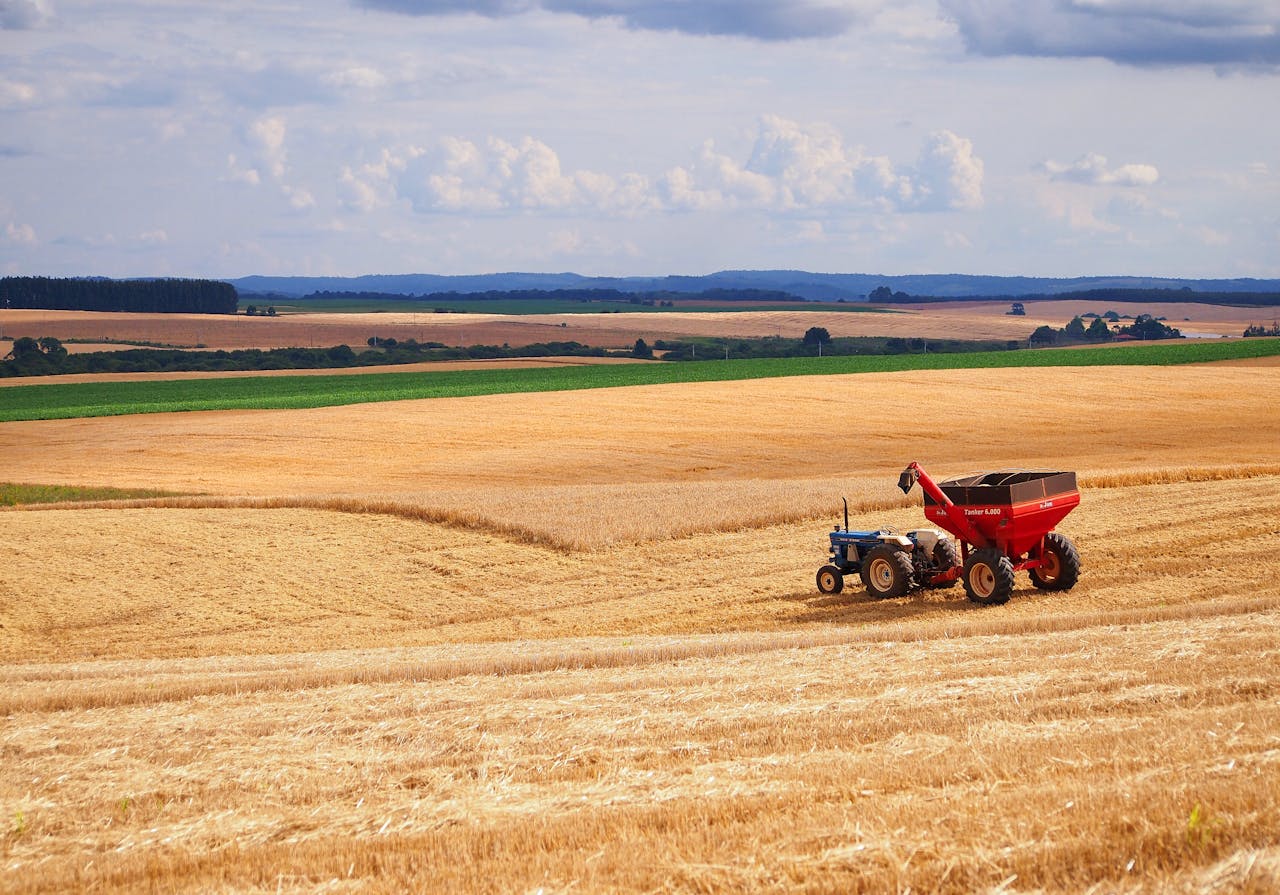 A tractor harvesting crops in a vast agricultural field in Entre Rios, Brazil.